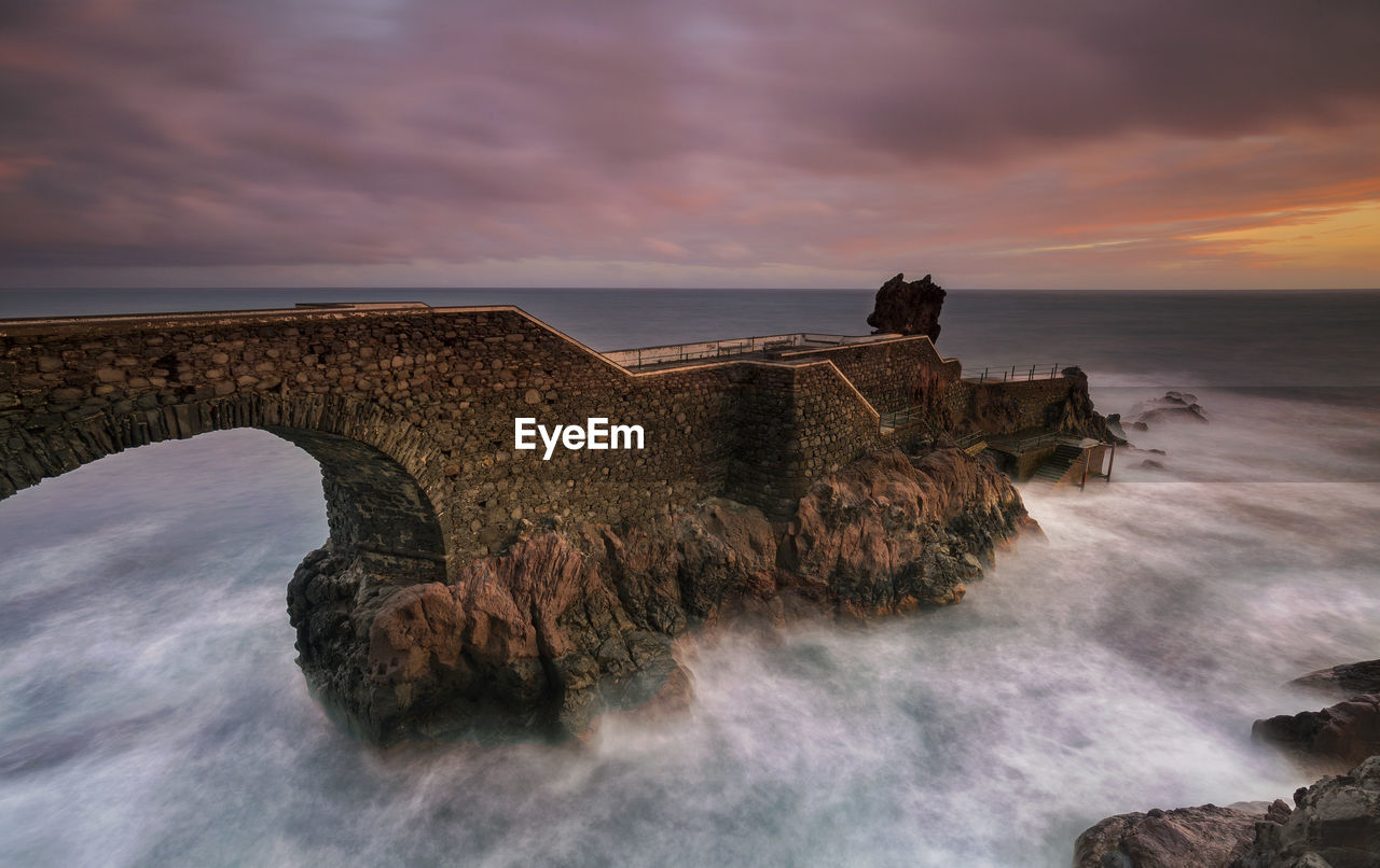 Scenic view of sea against cloudy sky