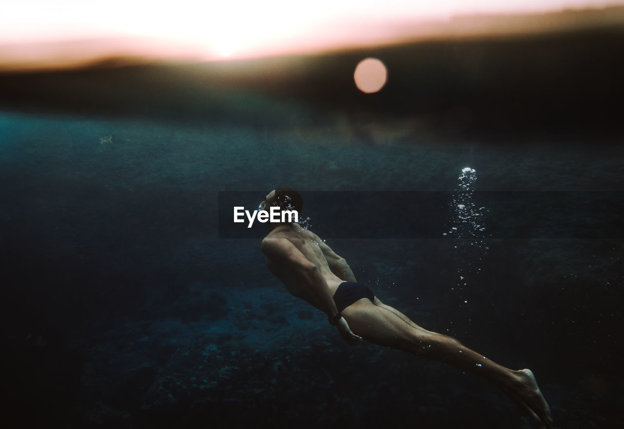 Side view of man swimming in sea