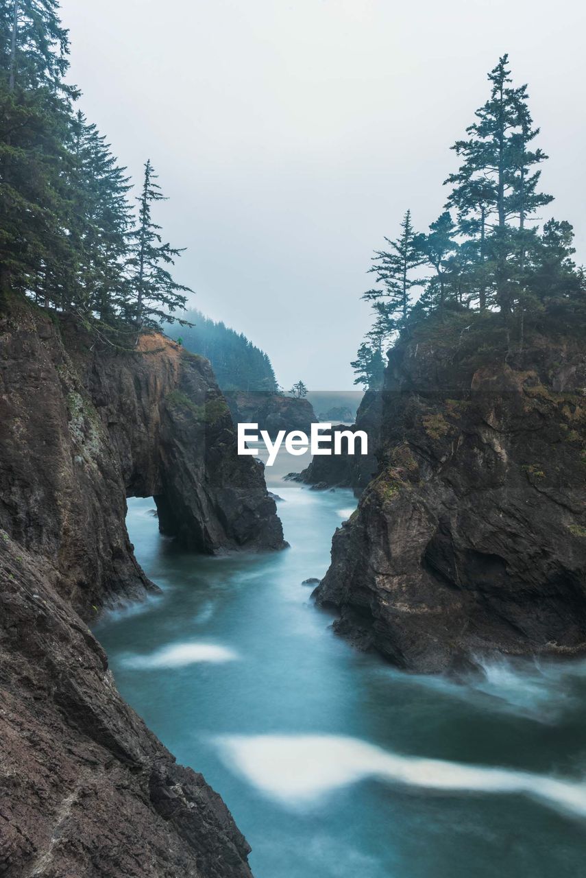 Scenic view of rocks in sea against sky