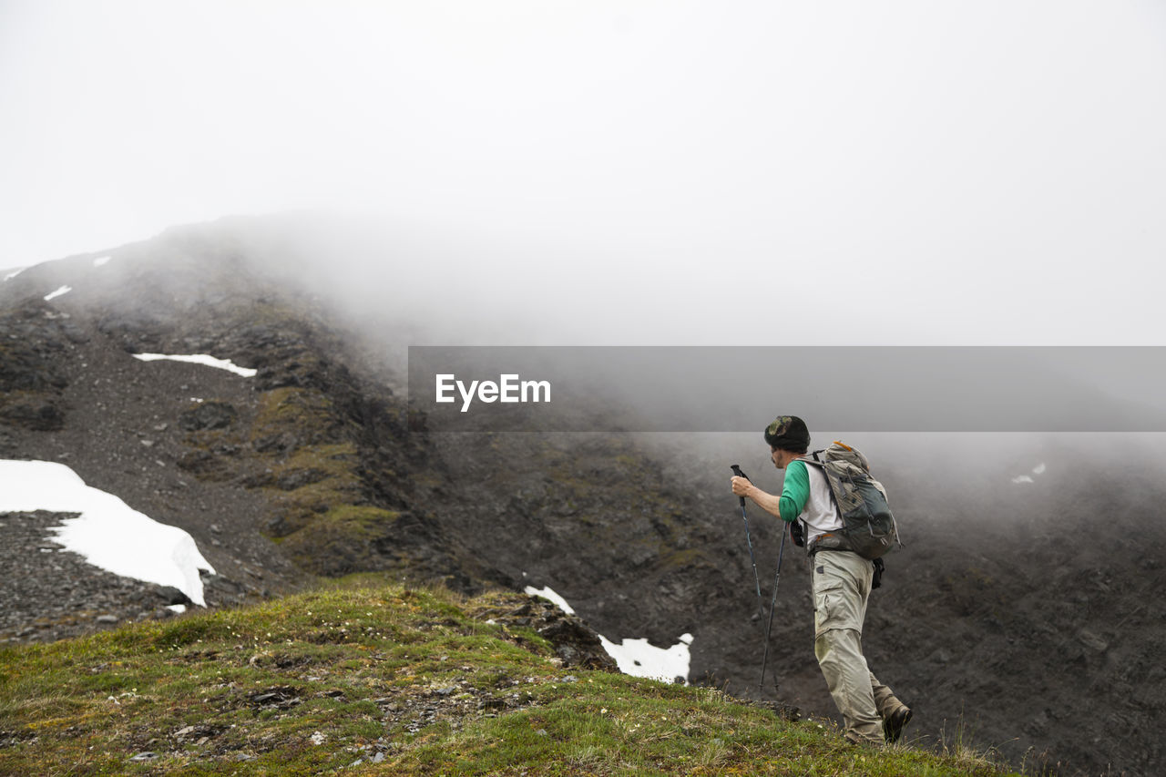 Man hikes ridge towards cooper mountain, kenai peninsula, alaska