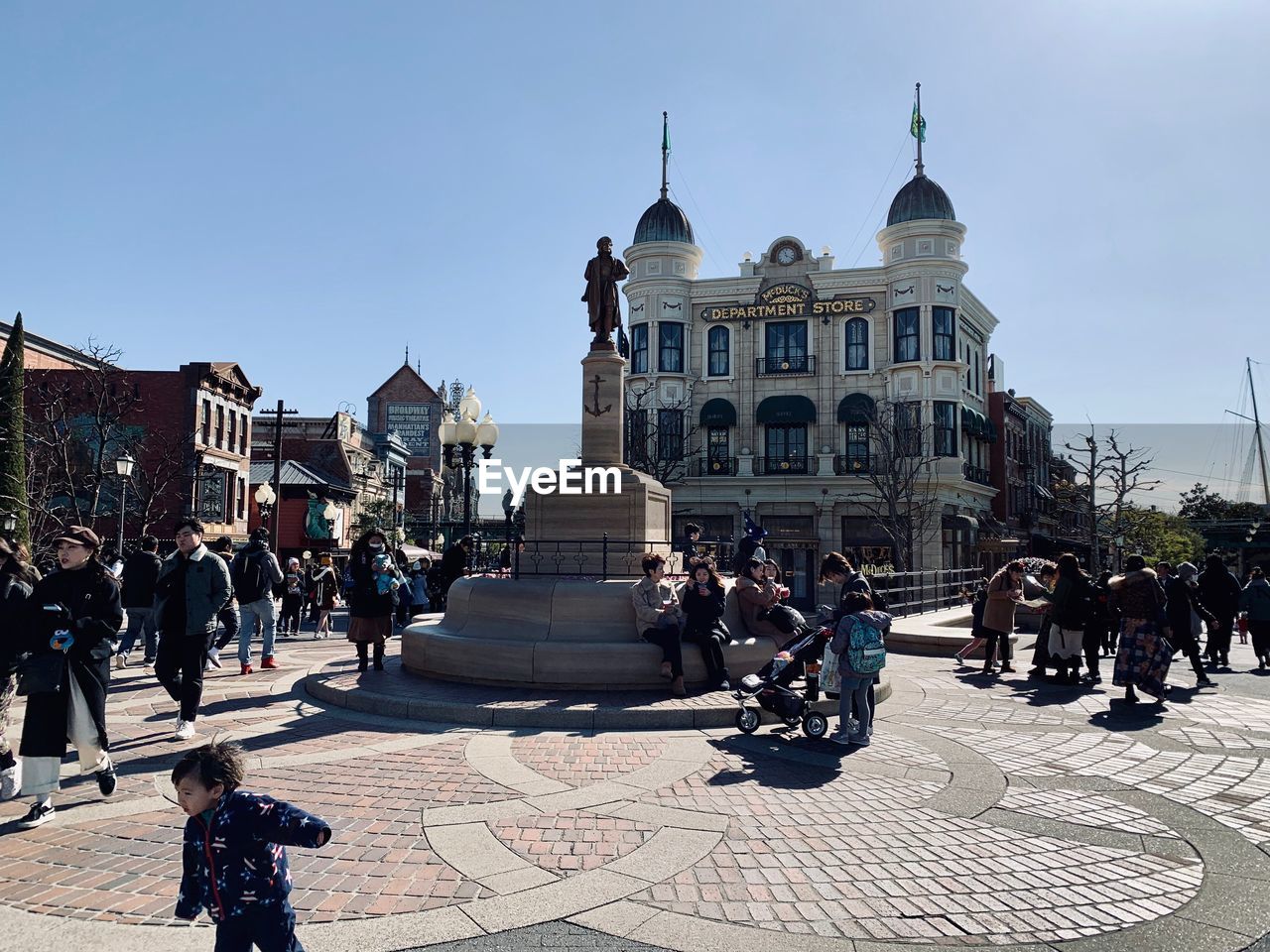 GROUP OF PEOPLE ON STREET AGAINST BUILDINGS