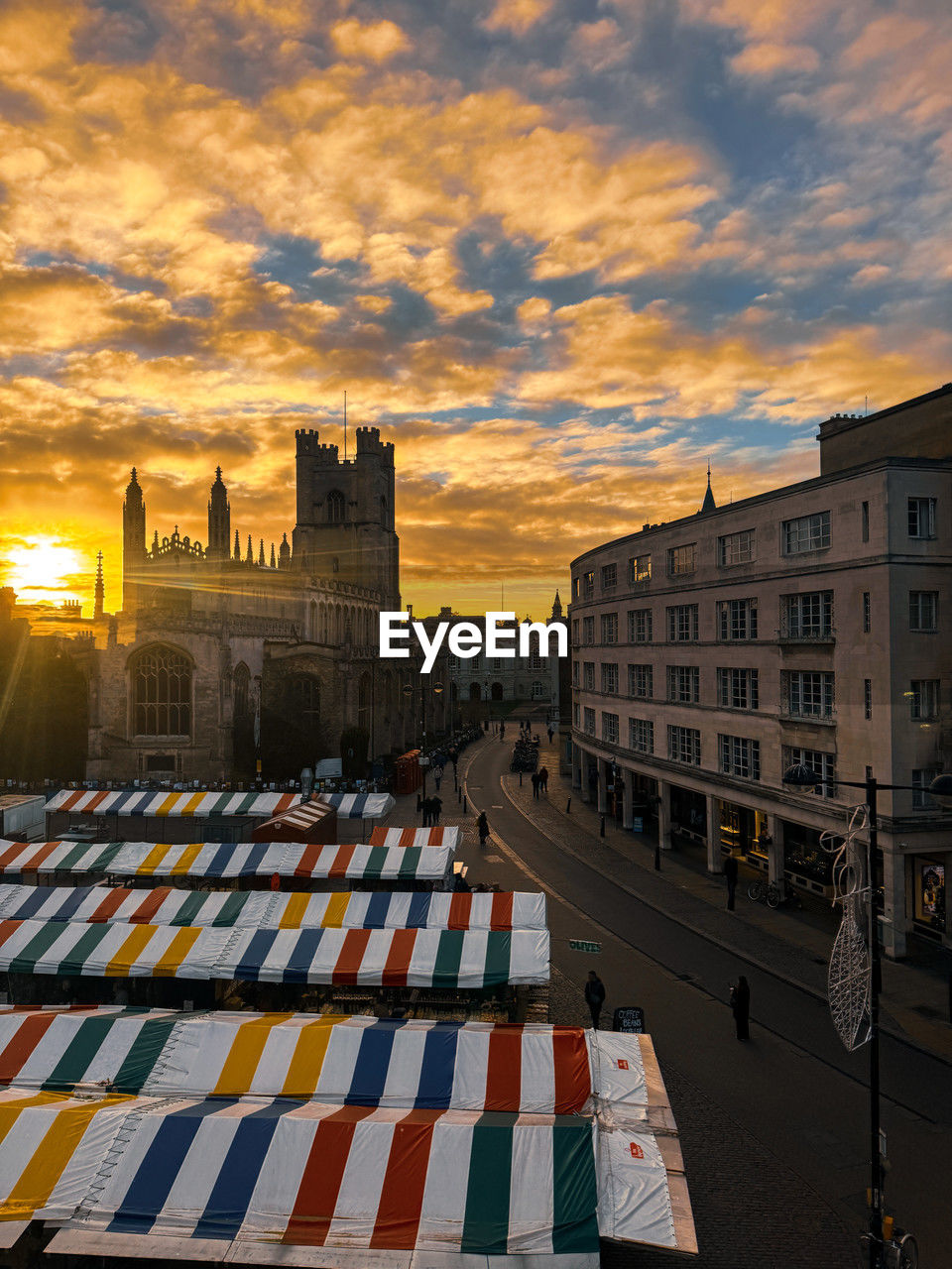 architecture, sky, urban area, sunset, building exterior, built structure, cityscape, city, cloud, nature, evening, building, transportation, travel destinations, downtown, sun, dusk, mode of transportation, business, multi colored, outdoors, business finance and industry, water, travel, sunlight, industry, street, reflection, skyline, no people, high angle view