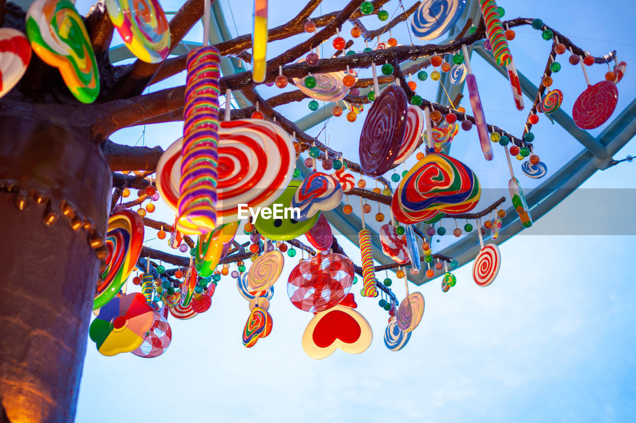 Low angle view of lanterns hanging against sky