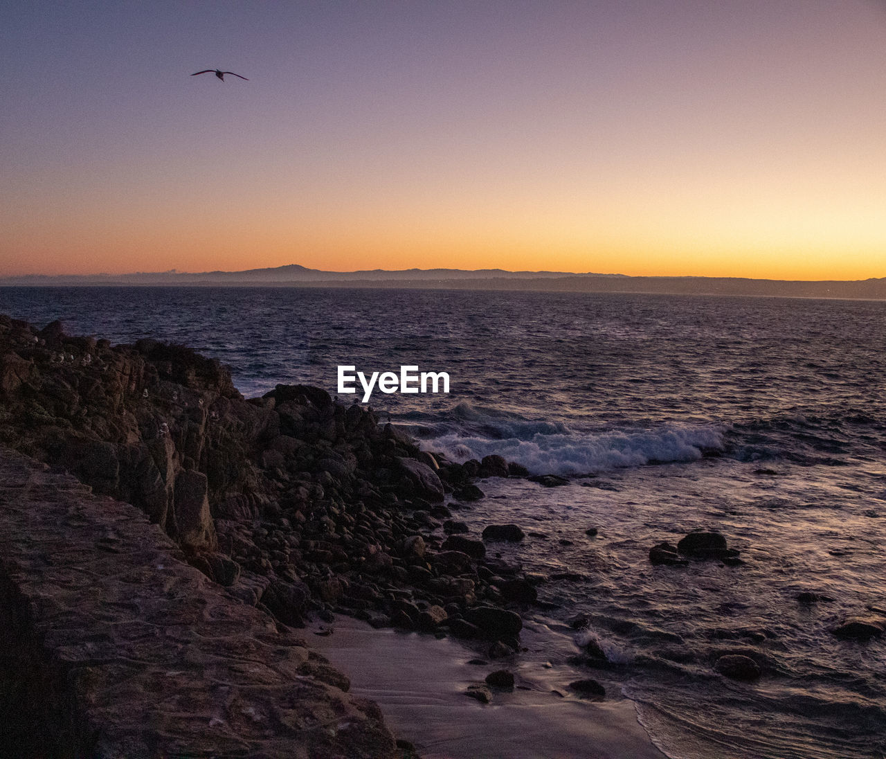 Scenic view of sea against clear sky during sunset