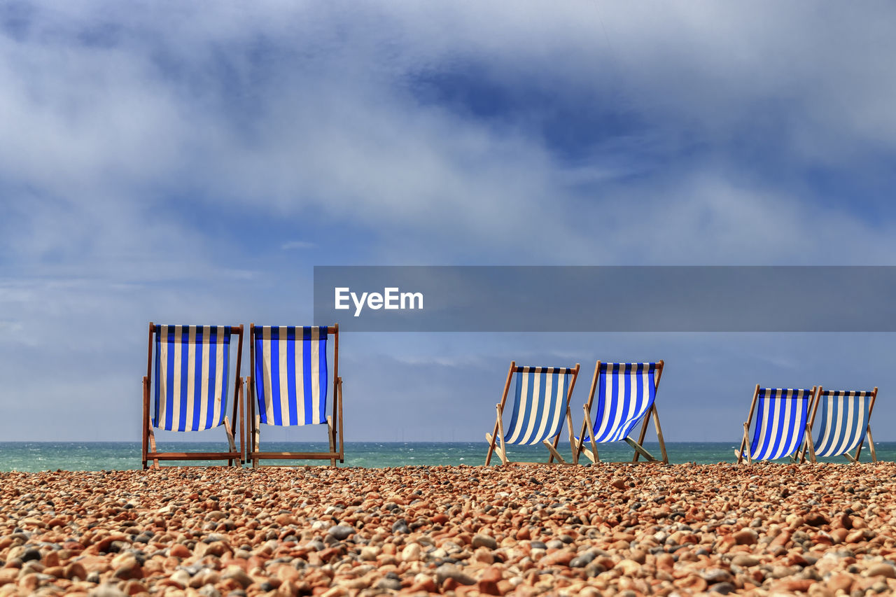 Deck share on the beach against the sky, brighton, england