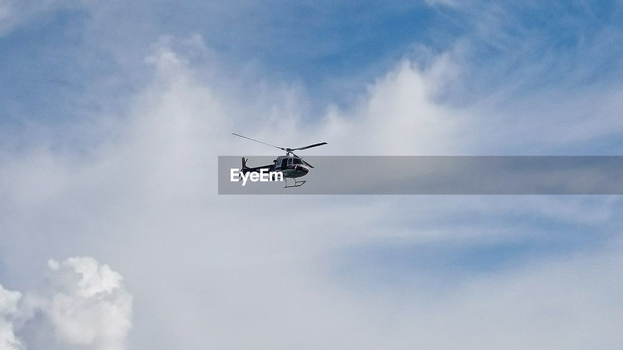 Low angle view of helicopter against the sky