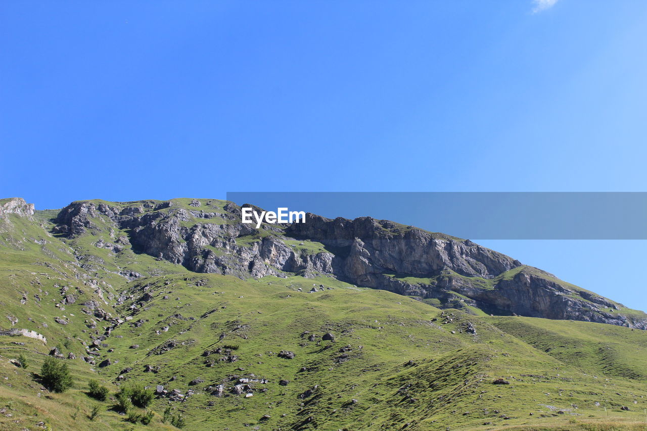 Scenic view of land against clear blue sky