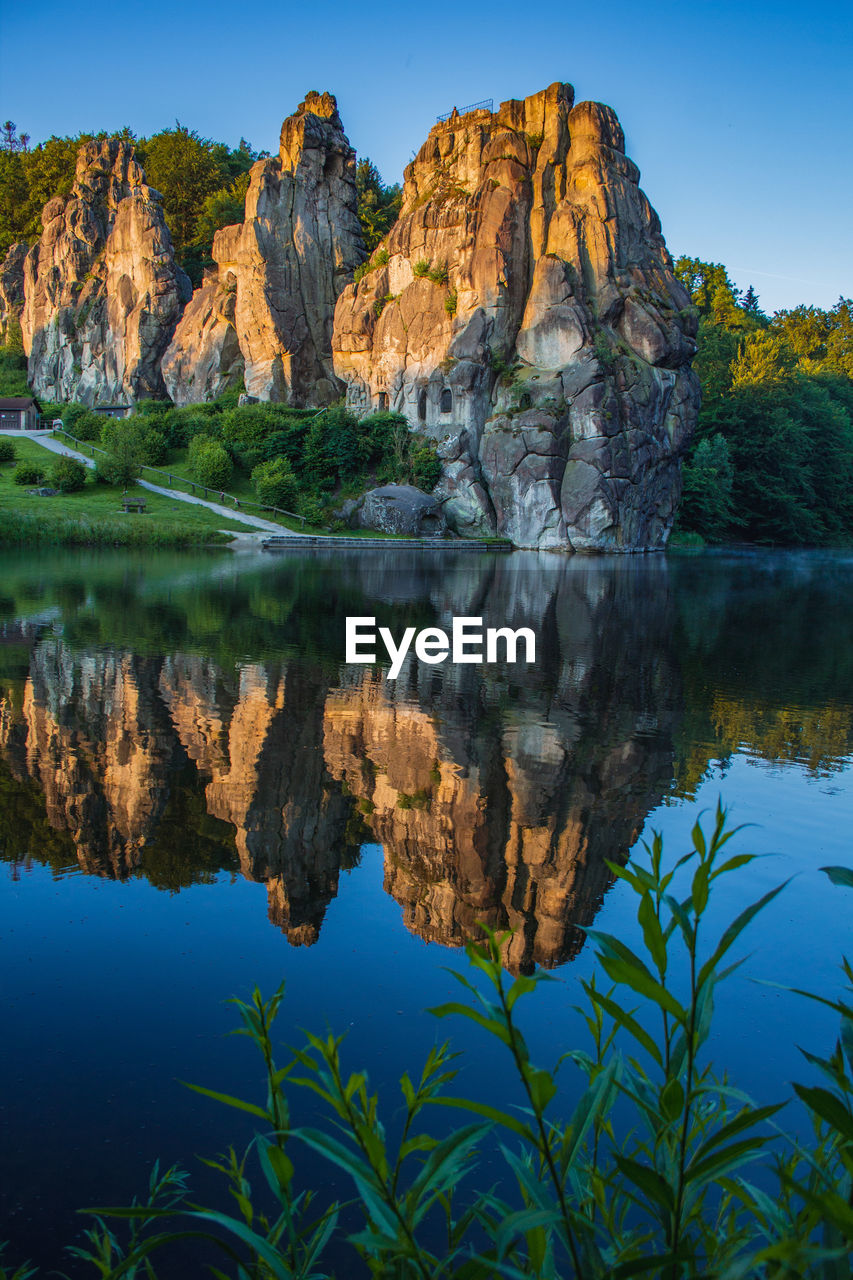 SCENIC VIEW OF LAKE AND ROCK FORMATION AGAINST SKY