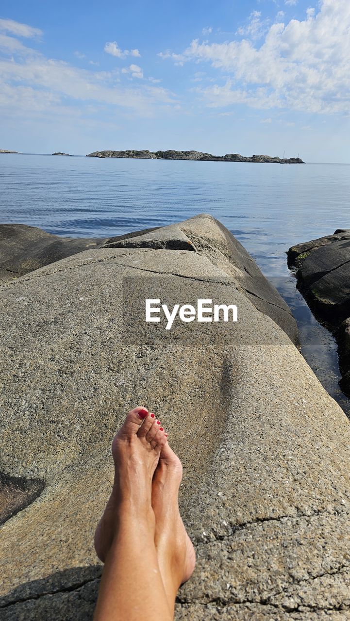 one person, hand, rock, nature, day, blue, water, sand, leisure activity, lifestyles, adventure, beach, outdoors, personal perspective, adult, rock climbing, barefoot, high angle view, close-up, women, sea, land