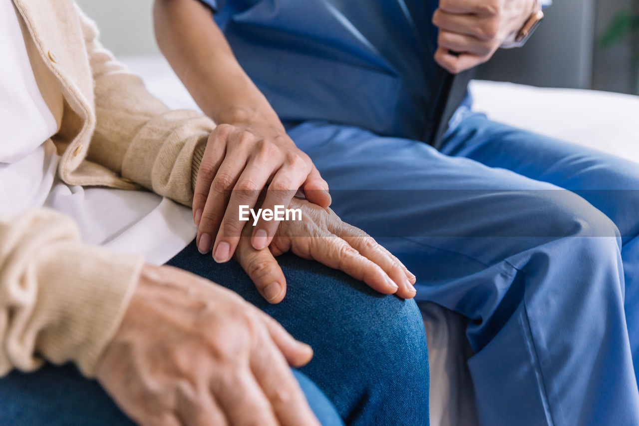 Midsection of doctor examining patient