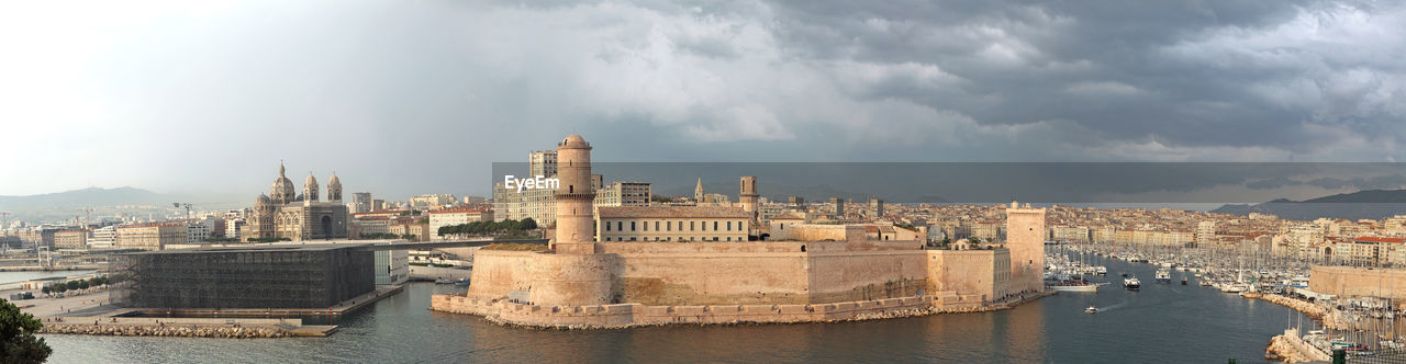 View of fort saint-jean from pharo palace in marseille under a cloudy and threatening sky