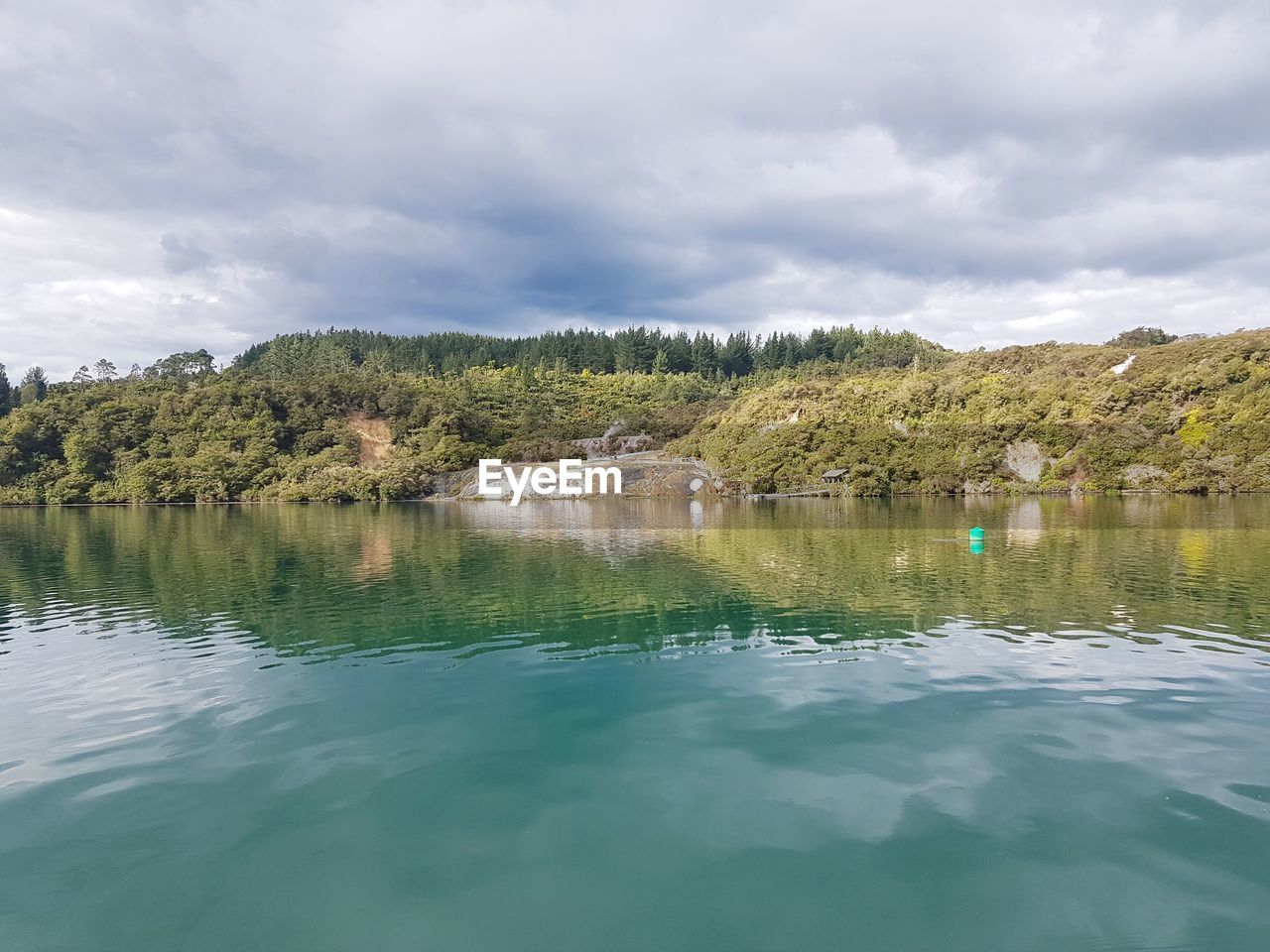 SCENIC VIEW OF LAKE WITH TREES AGAINST SKY