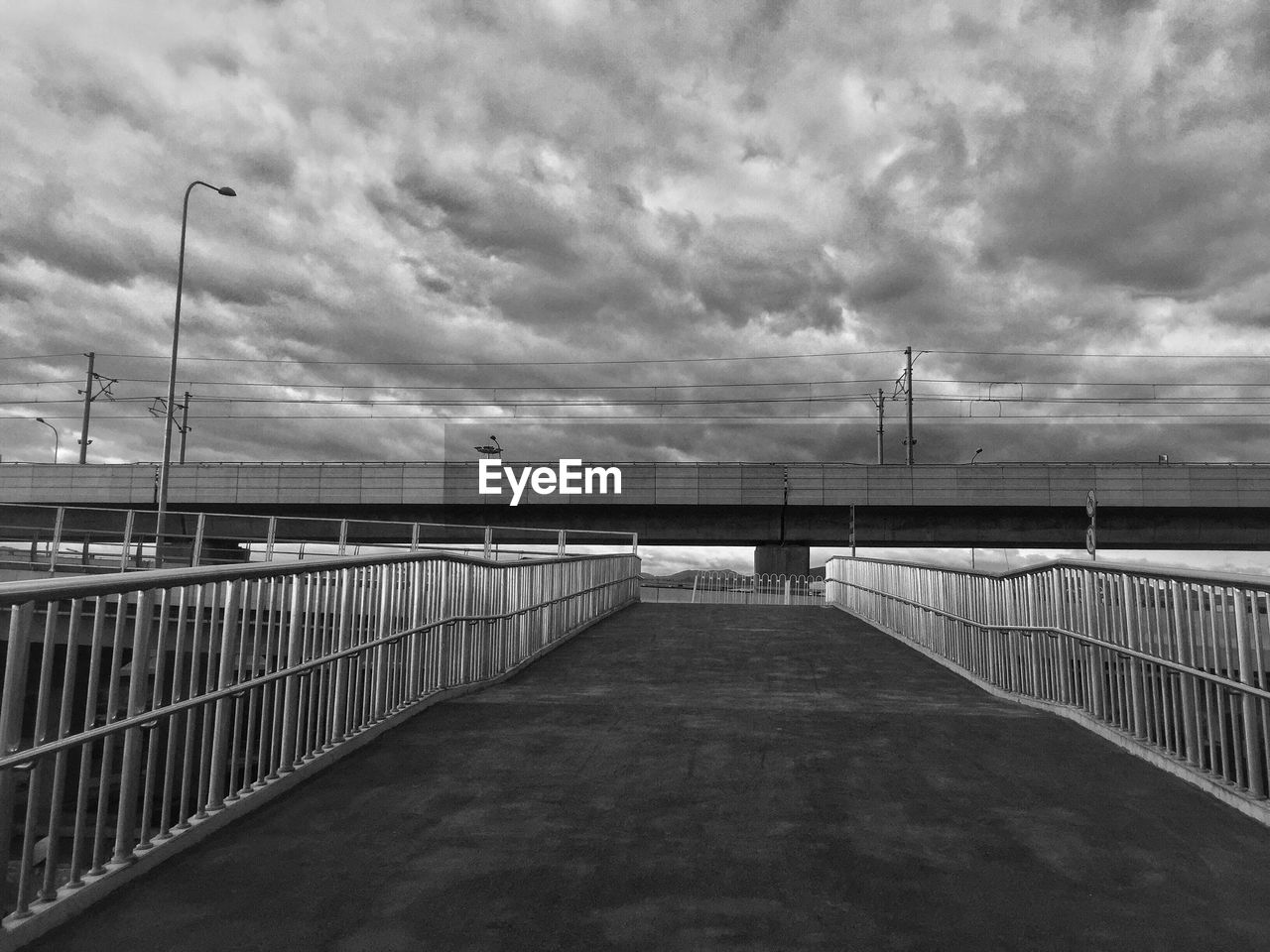 Bridge over street against sky