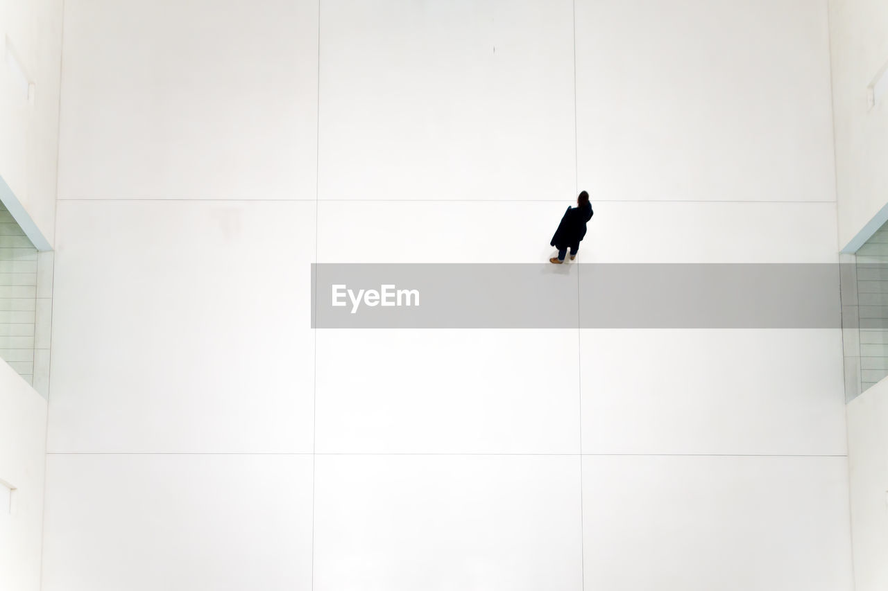 High angle view of woman standing on floor