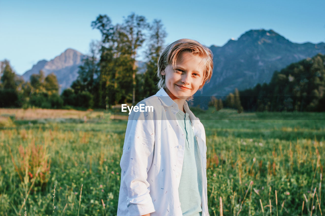 Portrait of smiling boy standing on land