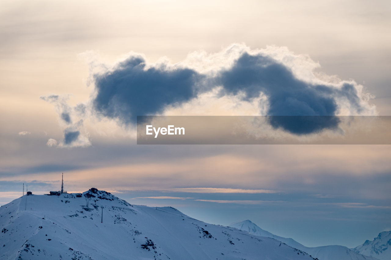 Scenic view of snow covered mountains against sky