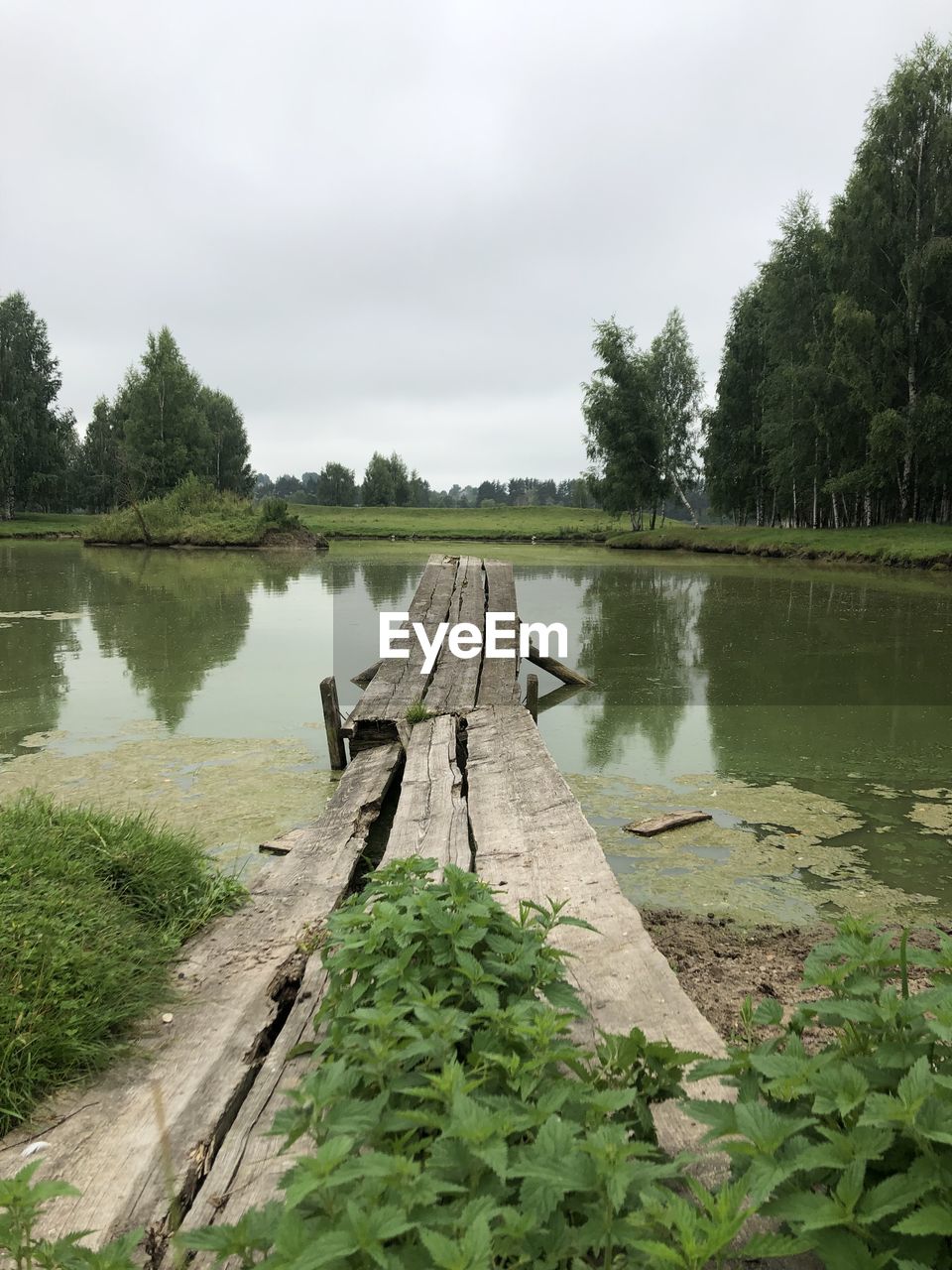 PIER AMIDST LAKE AGAINST SKY