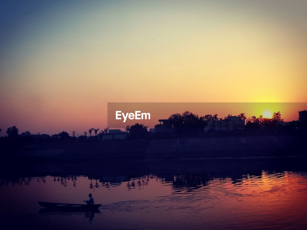 SILHOUETTE TREES BY RIVER AGAINST SKY DURING SUNSET