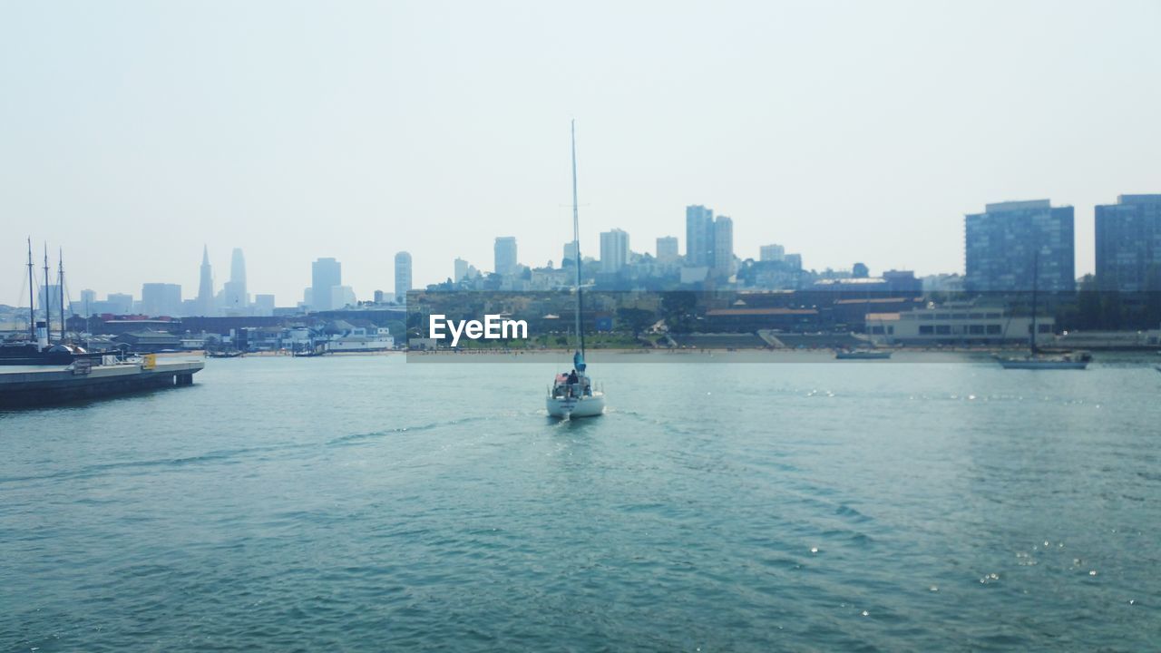 BOATS SAILING IN RIVER