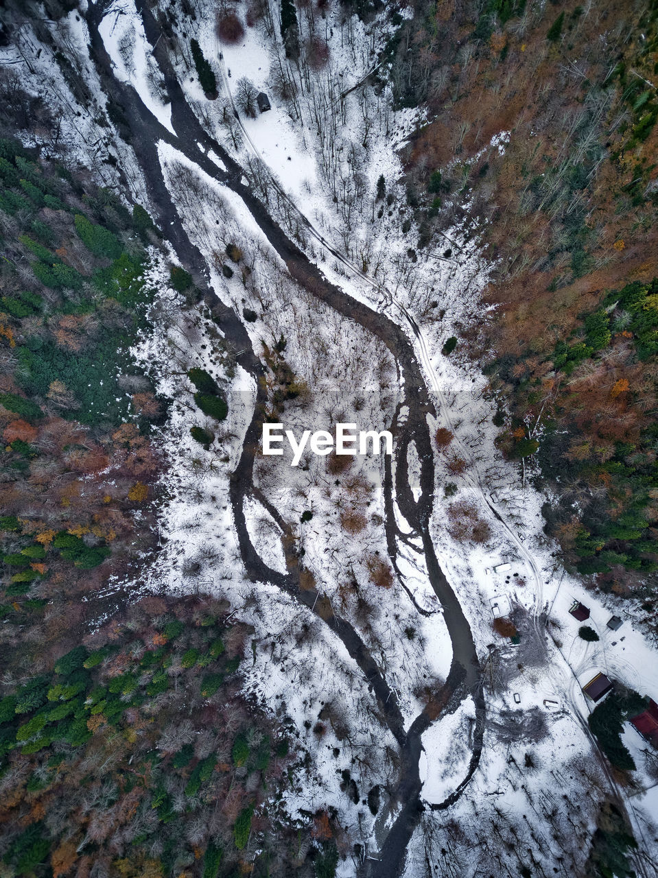 Aerial view of river flowing through snow-covered landscape