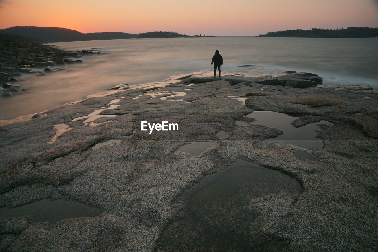 Rear view of man walking on beach