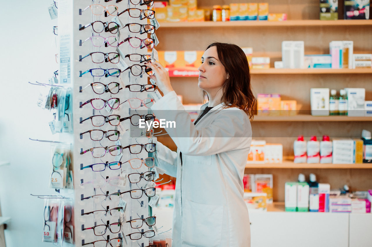 Female optometrist working at store