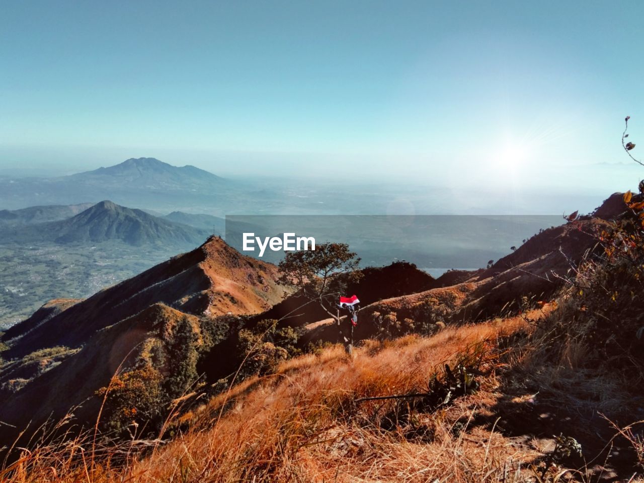 PEOPLE ON MOUNTAIN AGAINST SKY