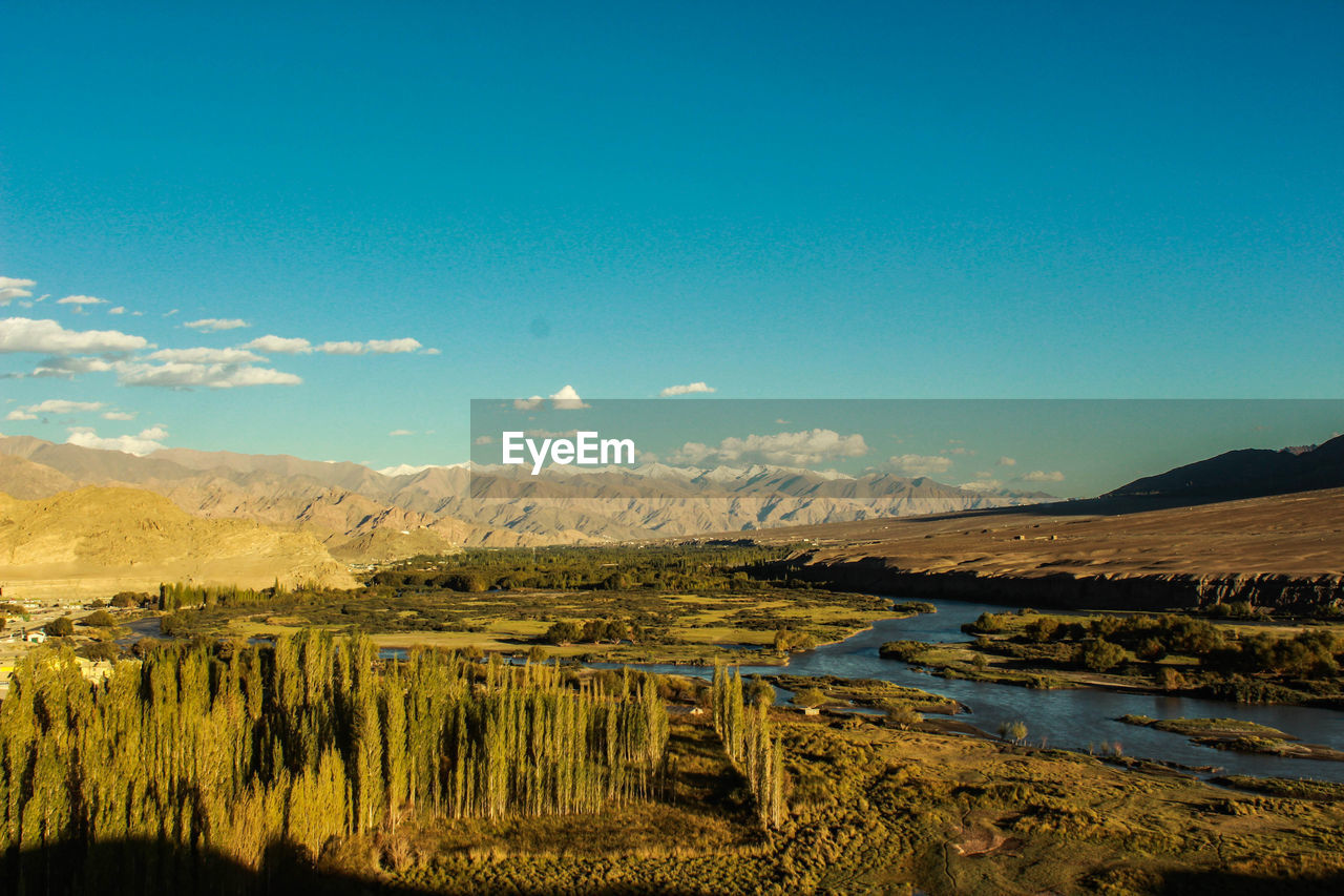 Scenic view of lake against blue sky