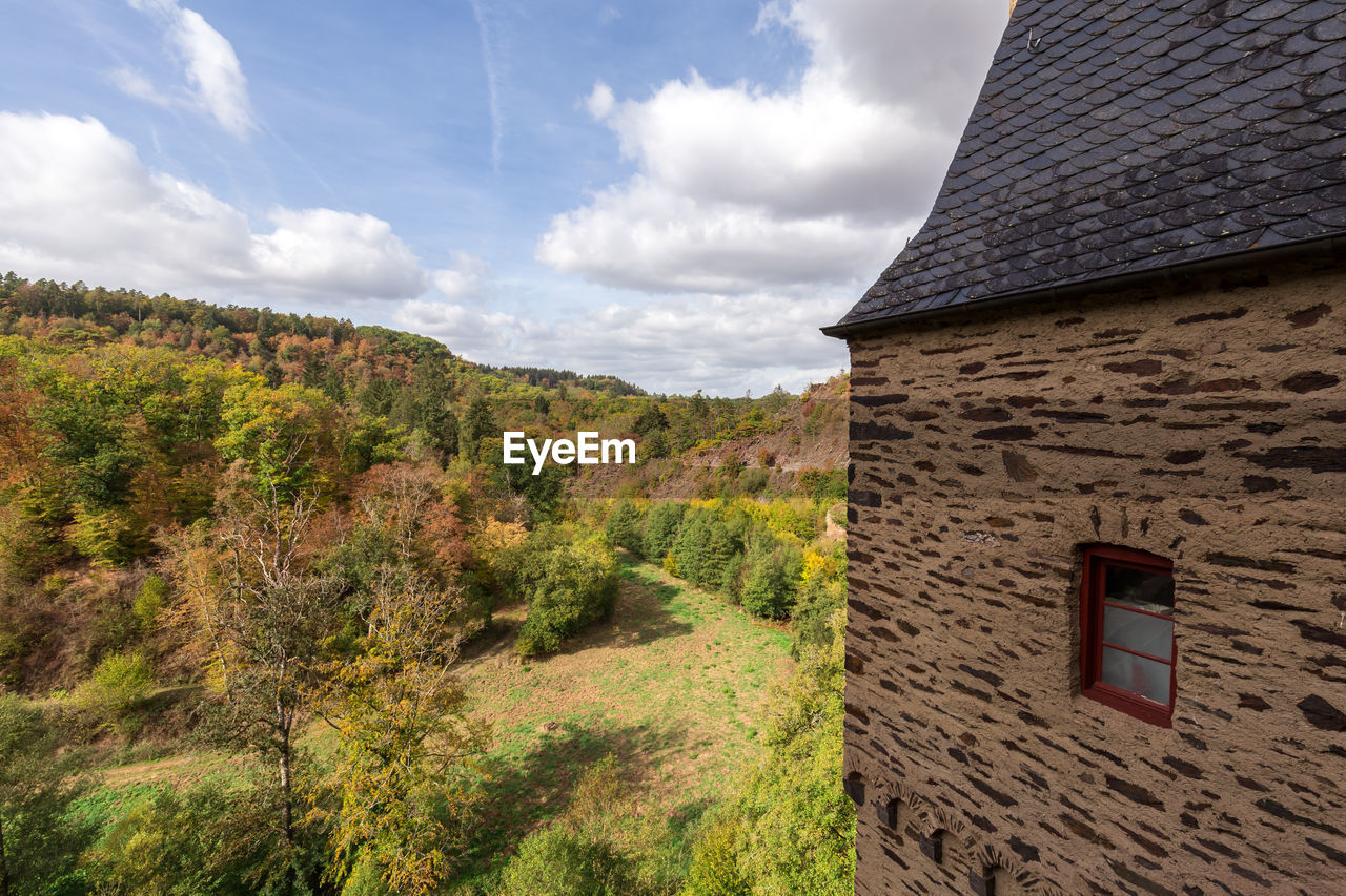 PANORAMIC VIEW OF TREES AND BUILDING AGAINST SKY