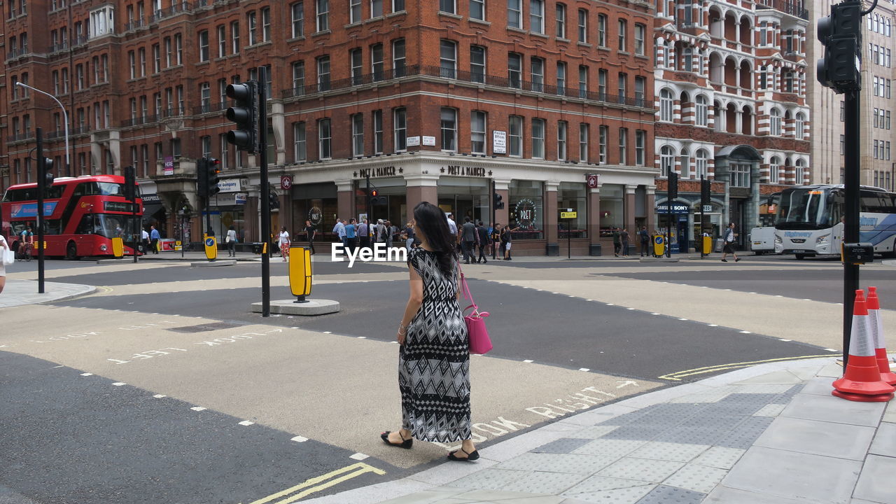 WOMAN WALKING ON CITY STREET