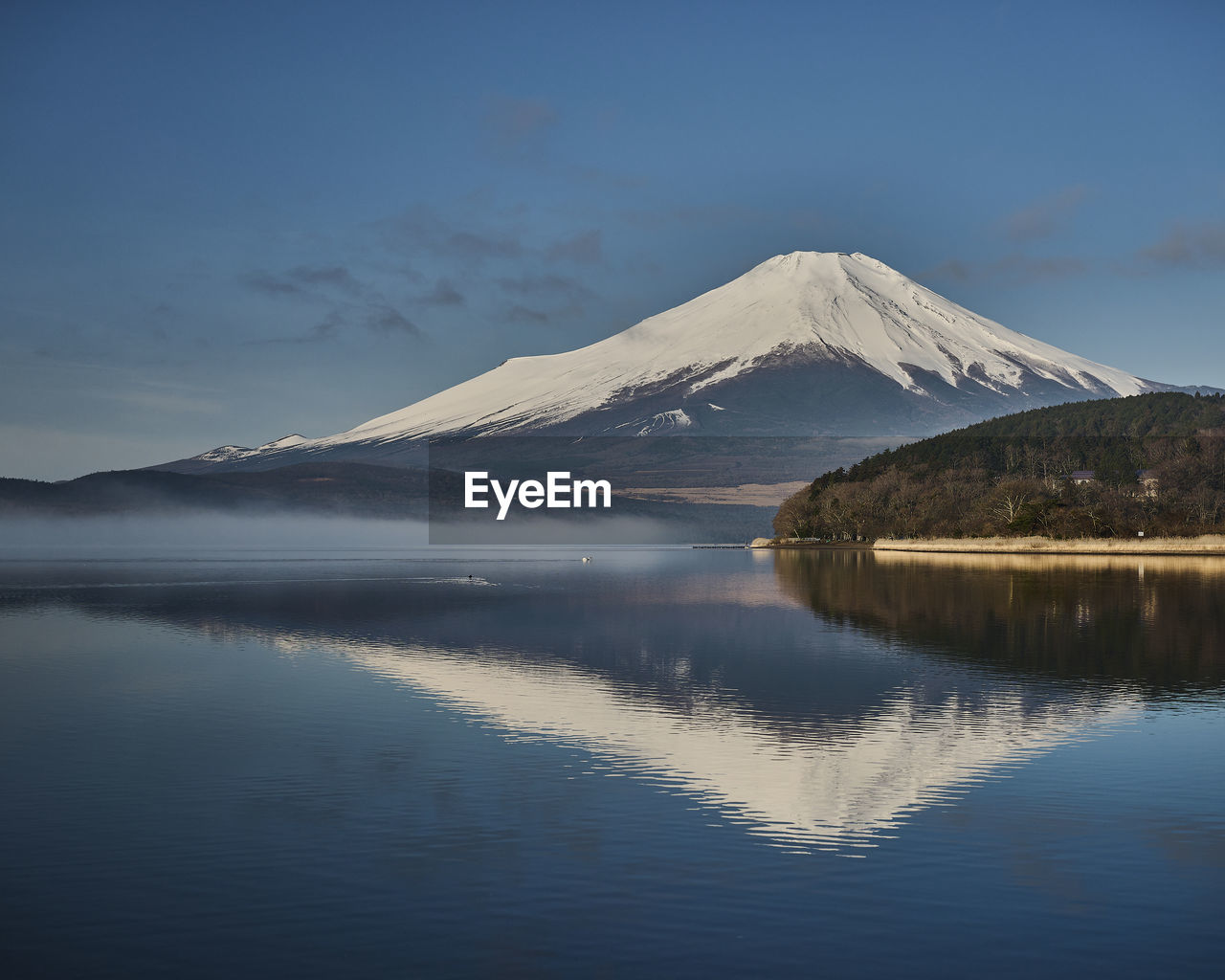 mountain, reflection, water, beauty in nature, scenics - nature, sky, lake, landscape, environment, nature, snow, tranquil scene, tranquility, cold temperature, dawn, travel destinations, volcano, no people, winter, non-urban scene, snowcapped mountain, morning, land, cloud, travel, outdoors, idyllic, blue, mountain peak, tourism, mountain range, reservoir, sunrise, day, horizon, stratovolcano