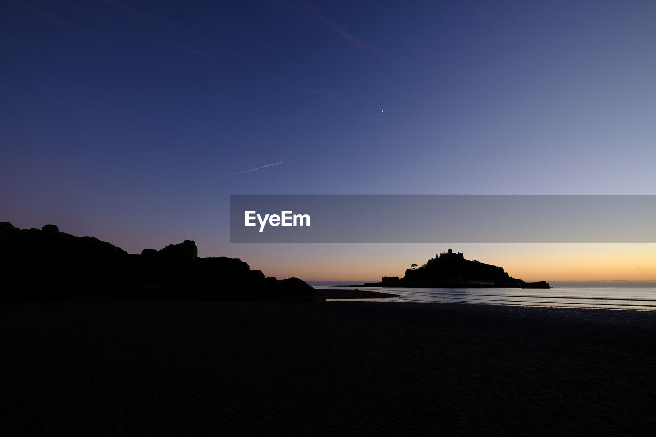 Scenic view of sea against sky at sunset