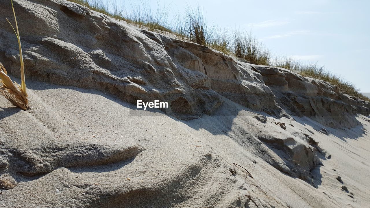 Scenic view of sand next to rock formation