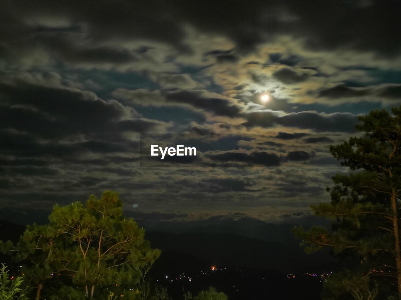 SCENIC VIEW OF STORM CLOUDS OVER MOON