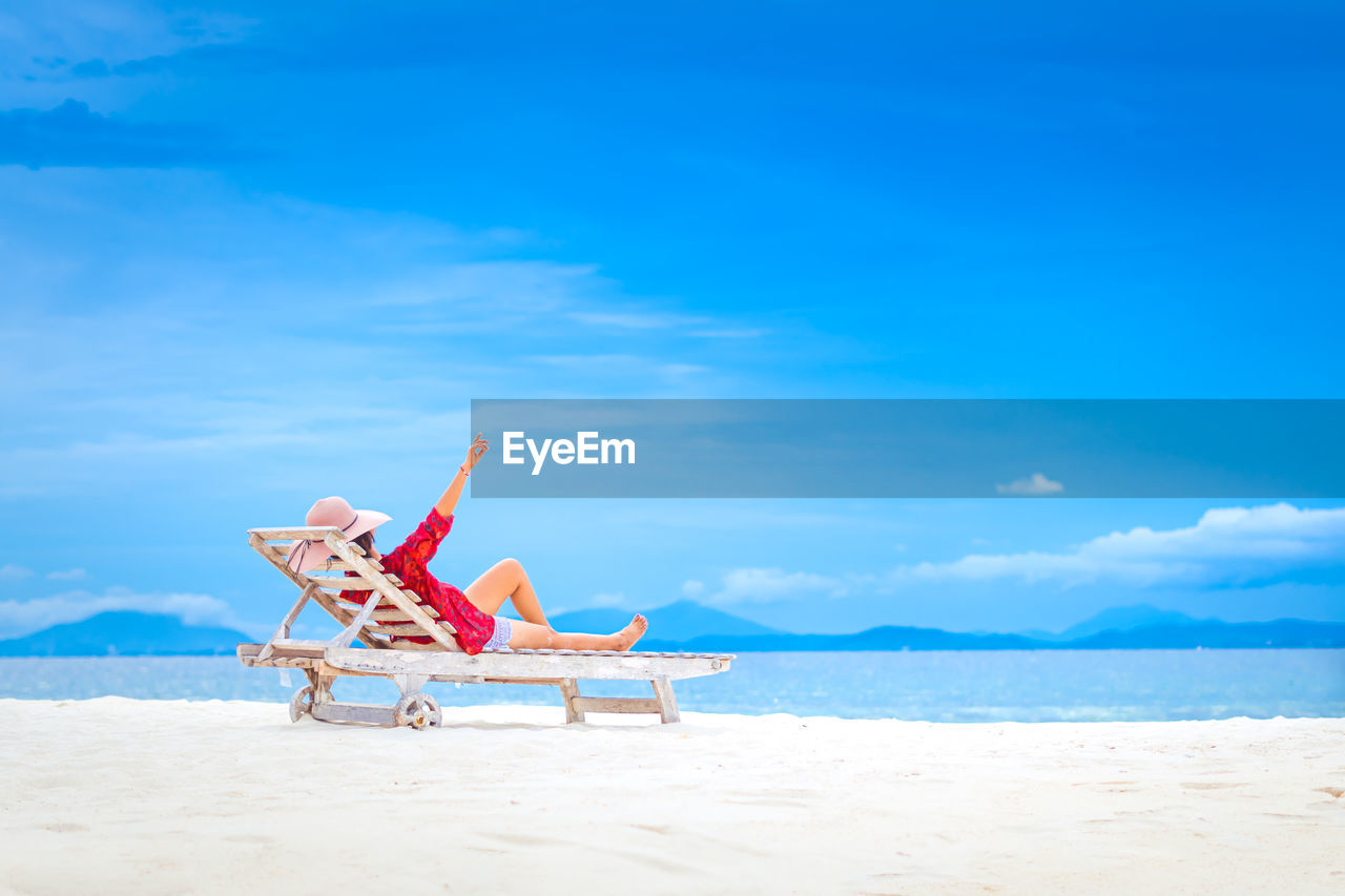 PERSON SITTING ON BEACH