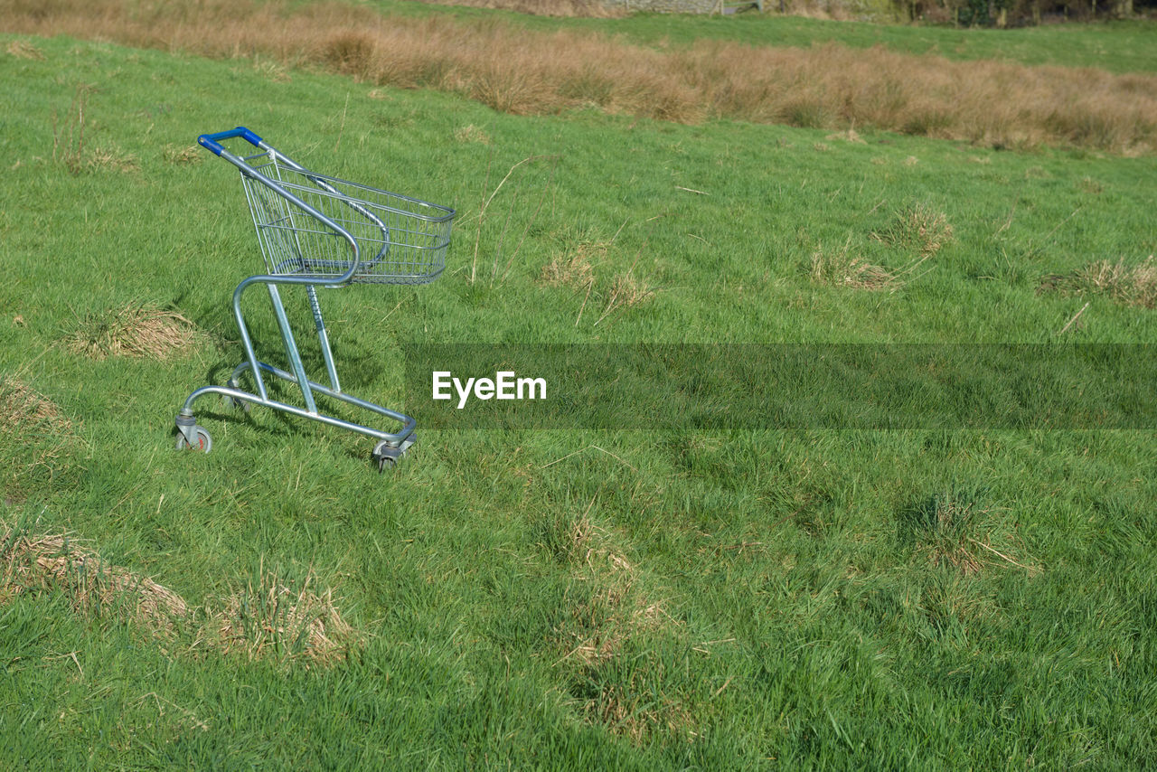 grass, lawn, plant, green, meadow, field, land, shopping cart, nature, no people, day, pasture, grassland, growth, prairie, absence, high angle view, empty, outdoors, tranquility, abandoned, landscape, agriculture, trolley, beauty in nature