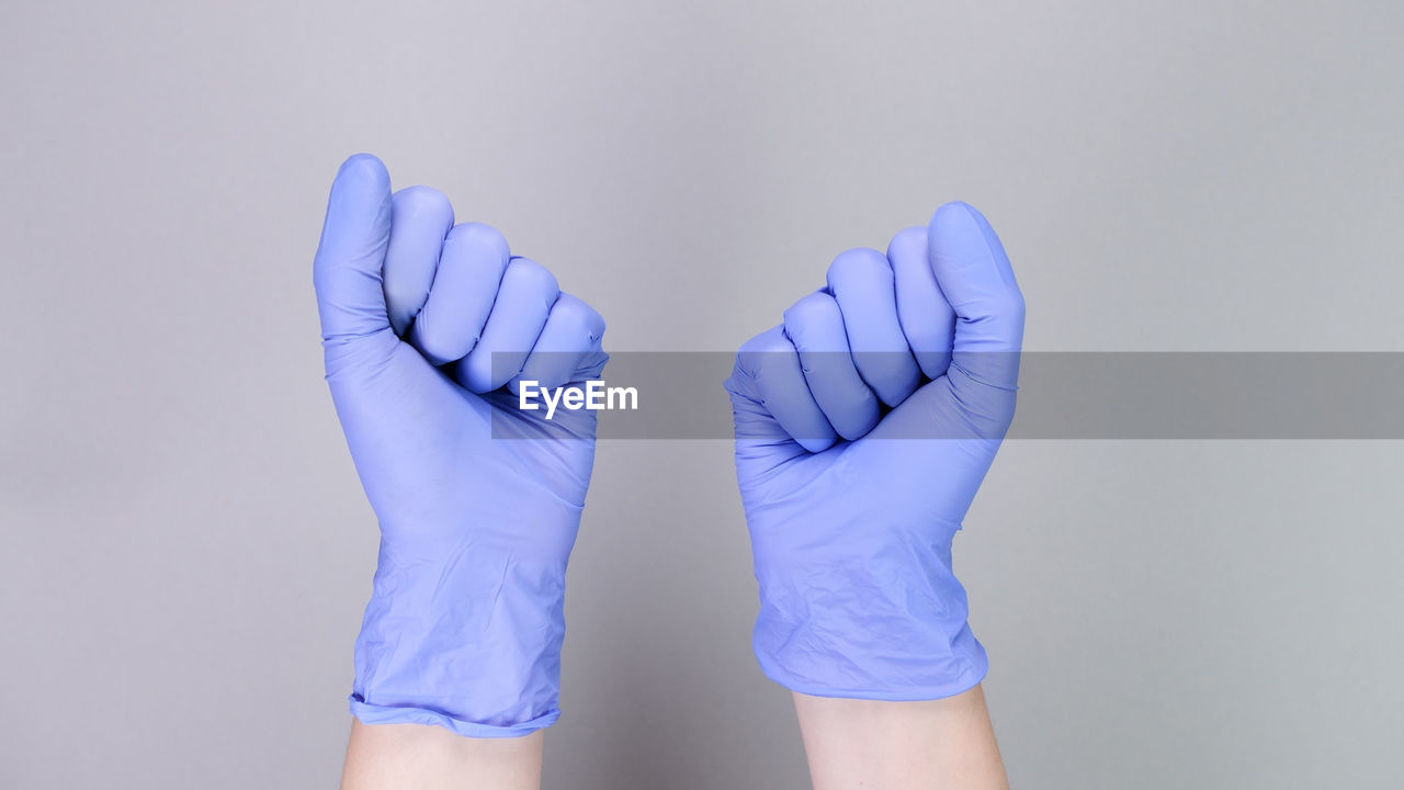 blue, arm, finger, hand, glove, studio shot, indoors, protection, one person, limb, protective workwear, purple, adult, gray background, protective glove, colored background, human limb, safety glove, security, clothing, healthcare and medicine, young adult, lifestyles