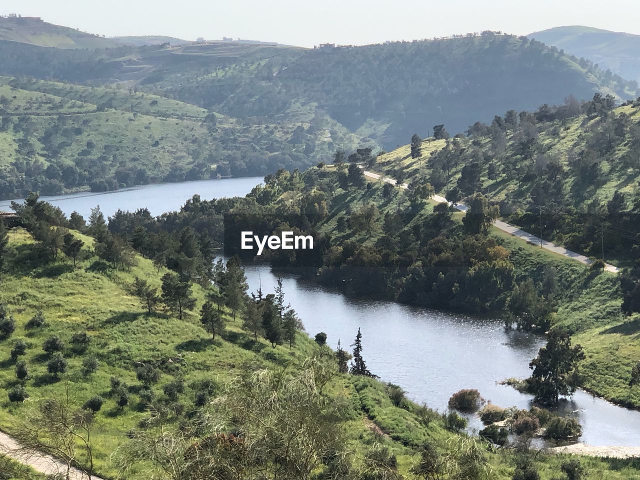 High angle view of river amidst trees and mountains