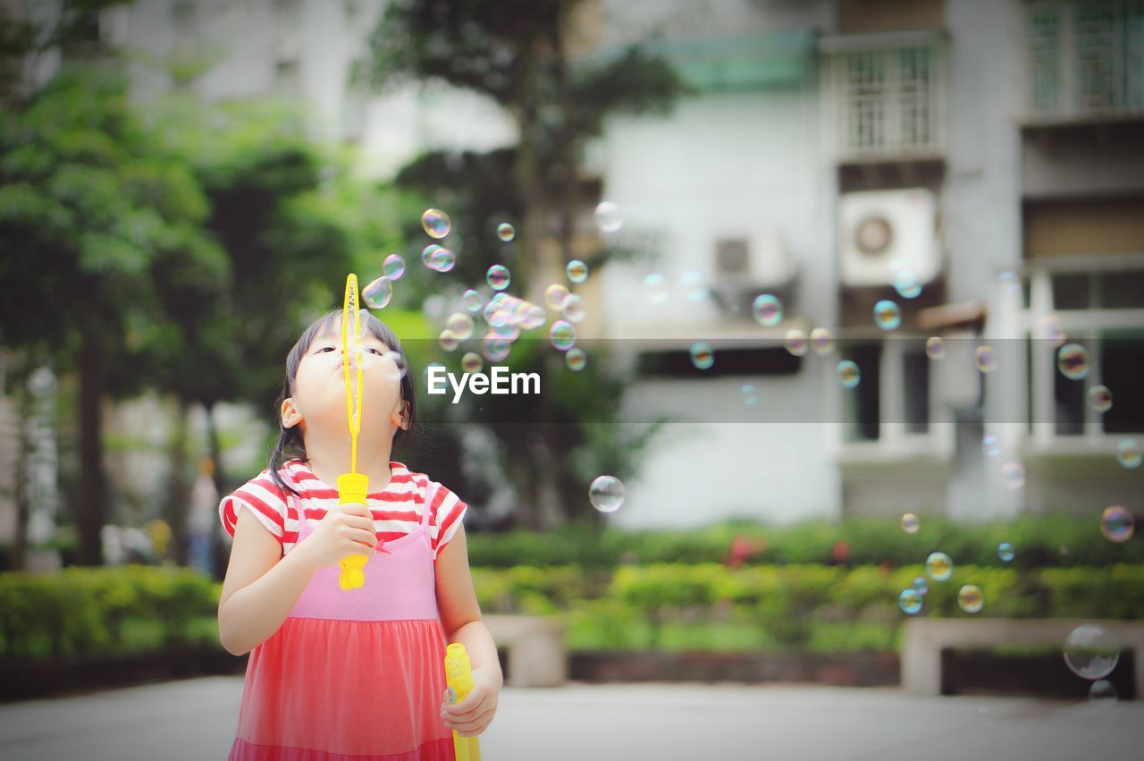 Girl playing with bubble wand