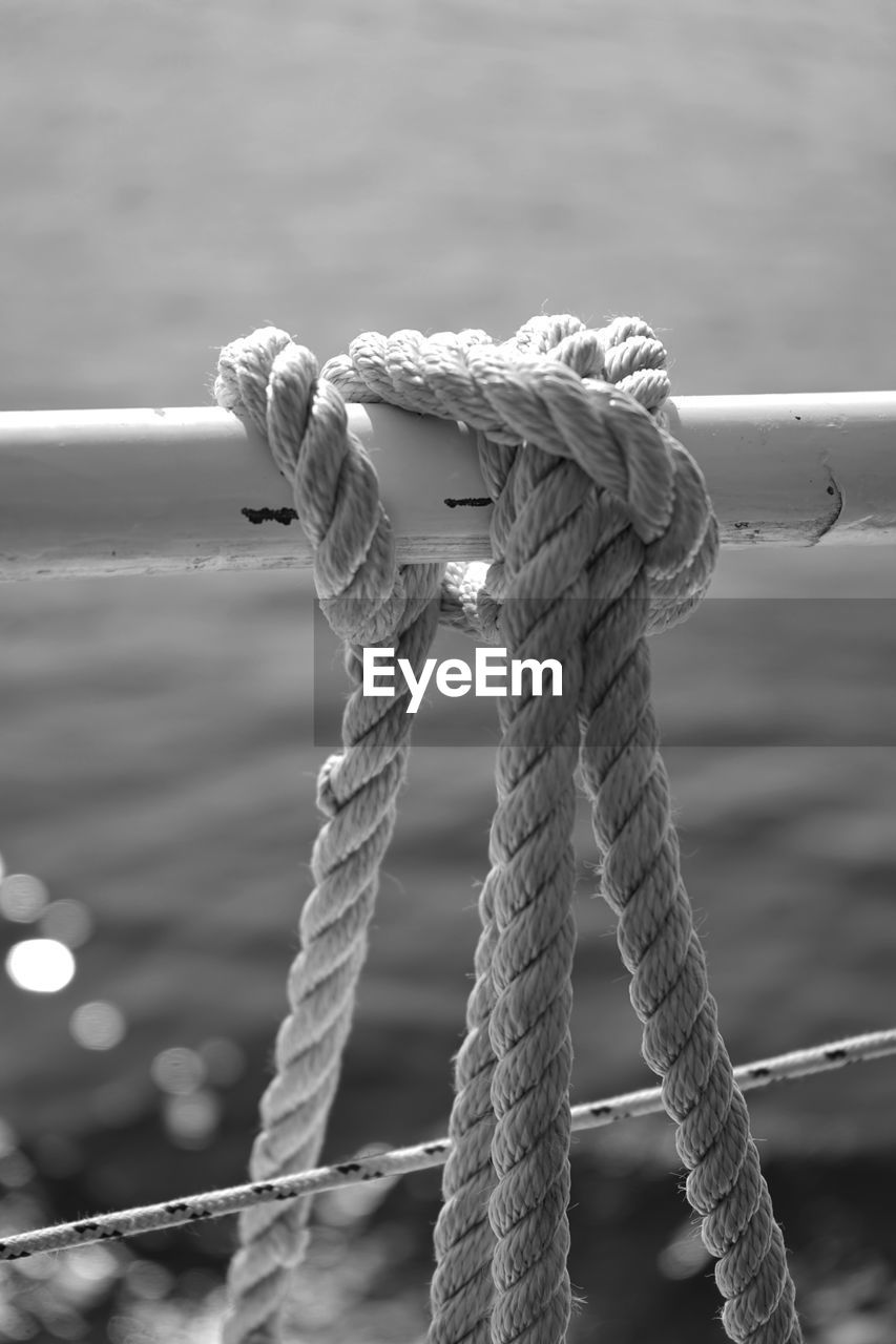 Close-up of rope tied on beach
