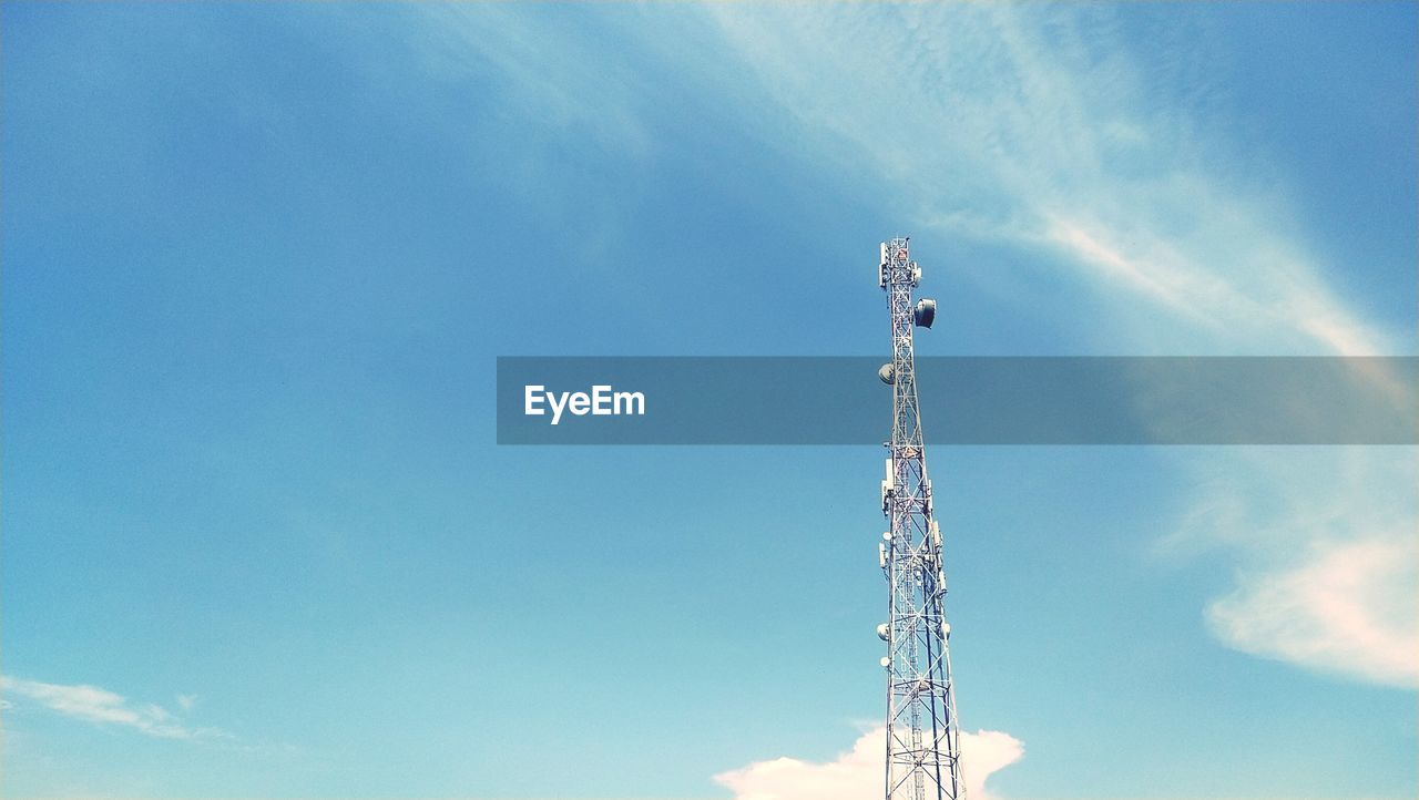 LOW ANGLE VIEW OF COMMUNICATIONS TOWER AGAINST CLOUDY SKY