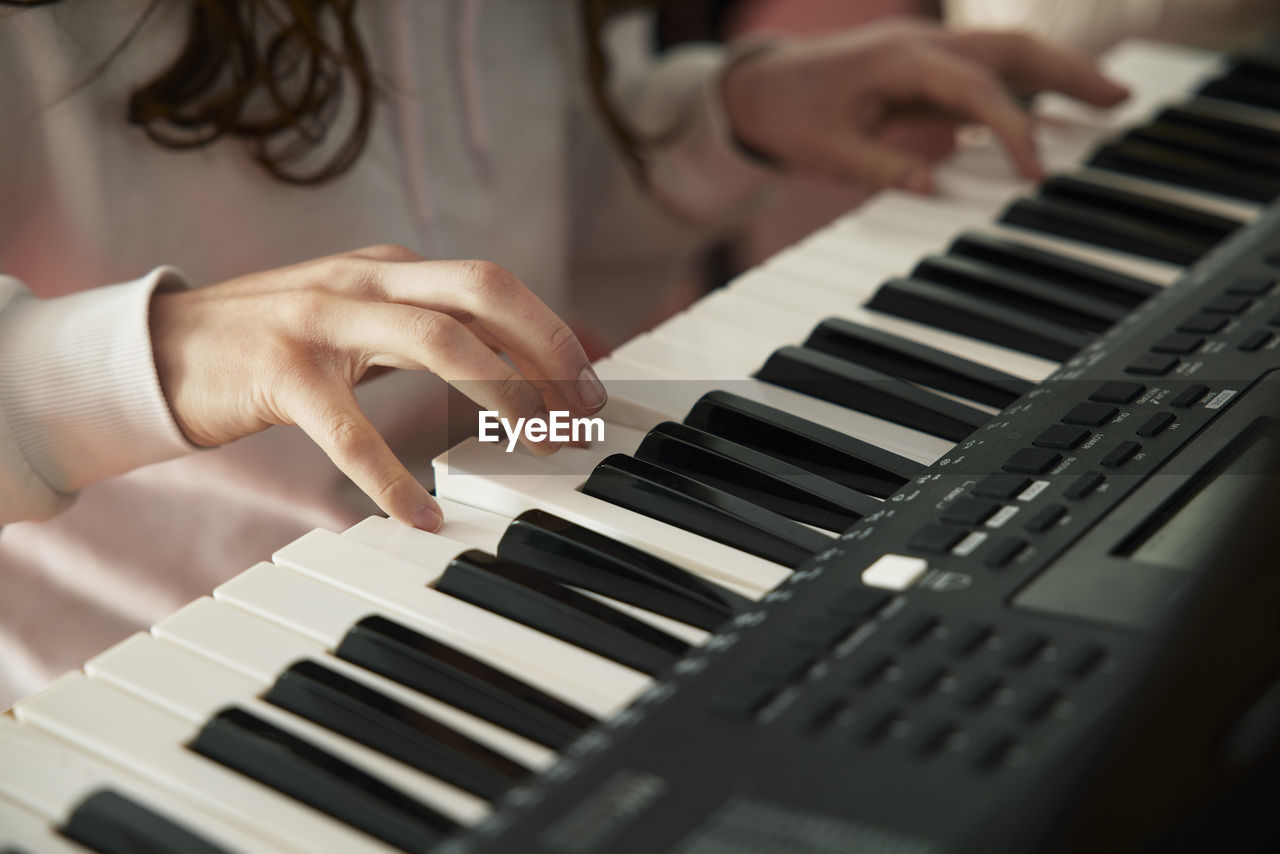 Teenage girl attending keyboard lesson