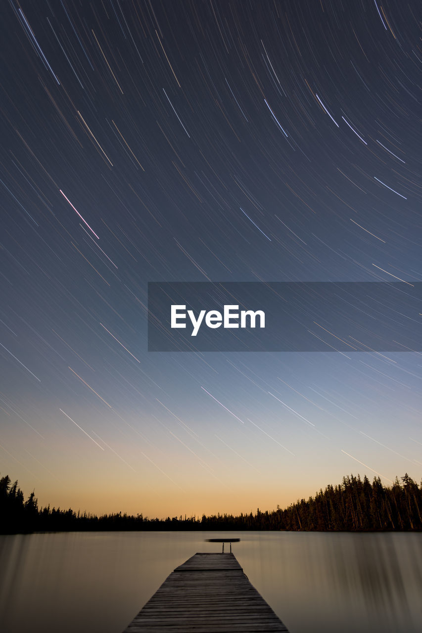 Scenic view of lake against sky at night