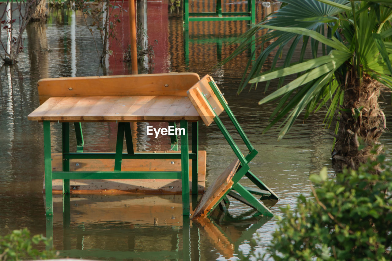 WOODEN BENCH IN WATER