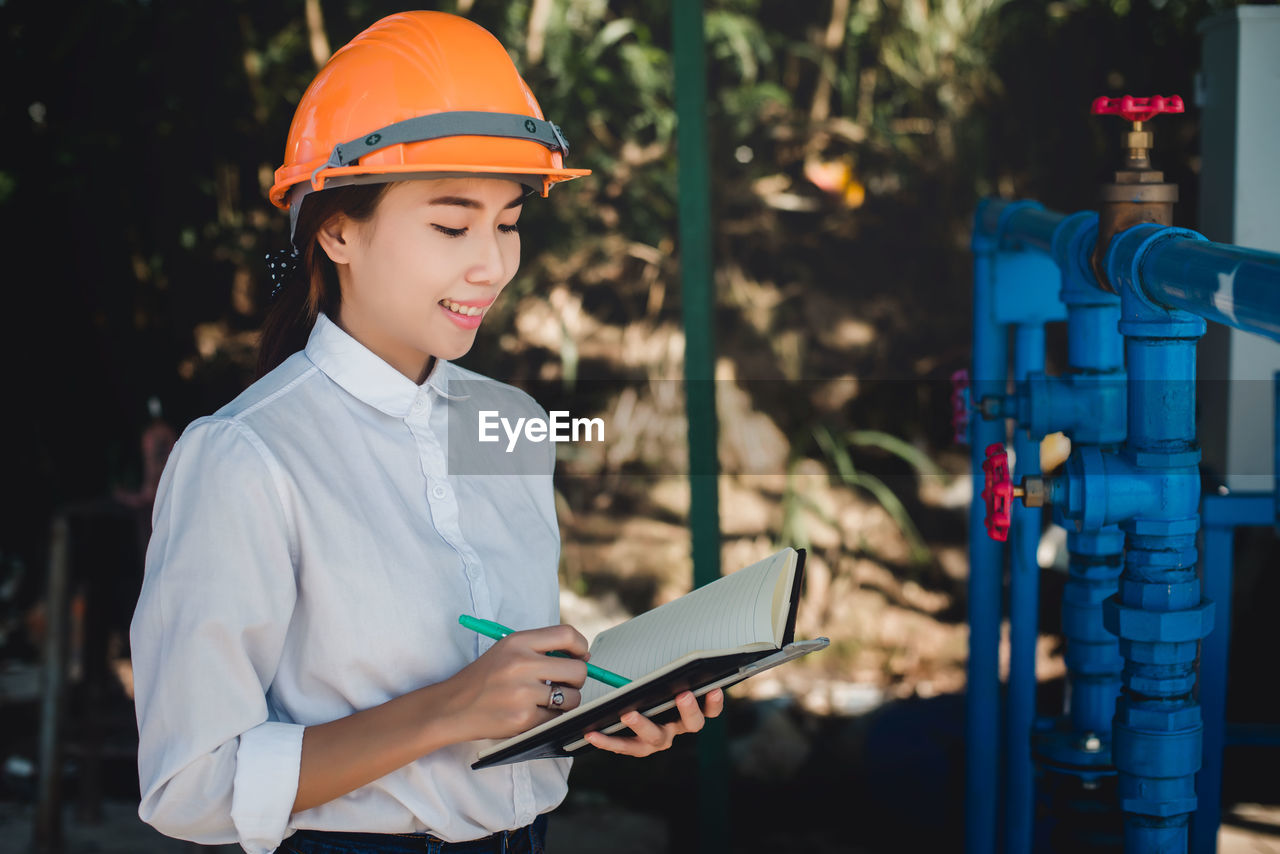 Side view of woman wearing hardhat