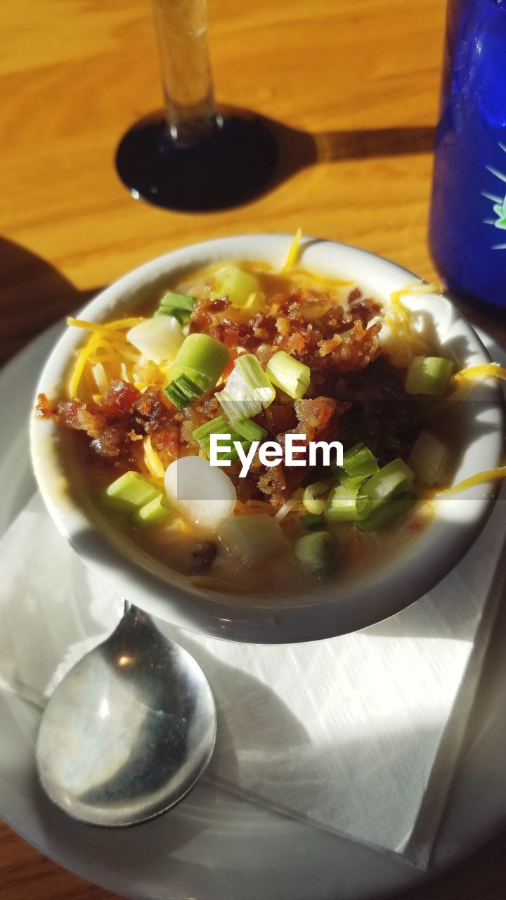 food and drink, food, healthy eating, dish, meal, vegetable, cuisine, wellbeing, kitchen utensil, freshness, table, eating utensil, produce, spoon, indoors, drink, no people, bowl, plate, soft drink, household equipment, stew, high angle view, breakfast, tableware, soup