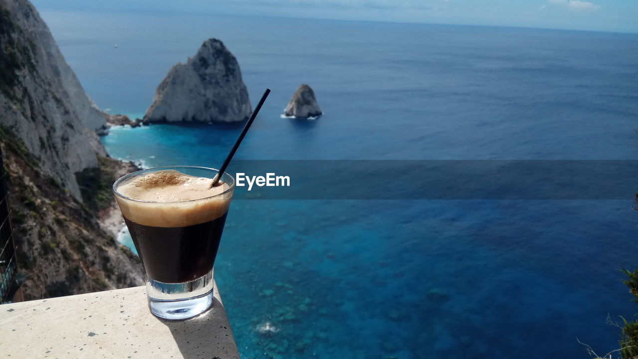 HIGH ANGLE VIEW OF SEA AND DRINK