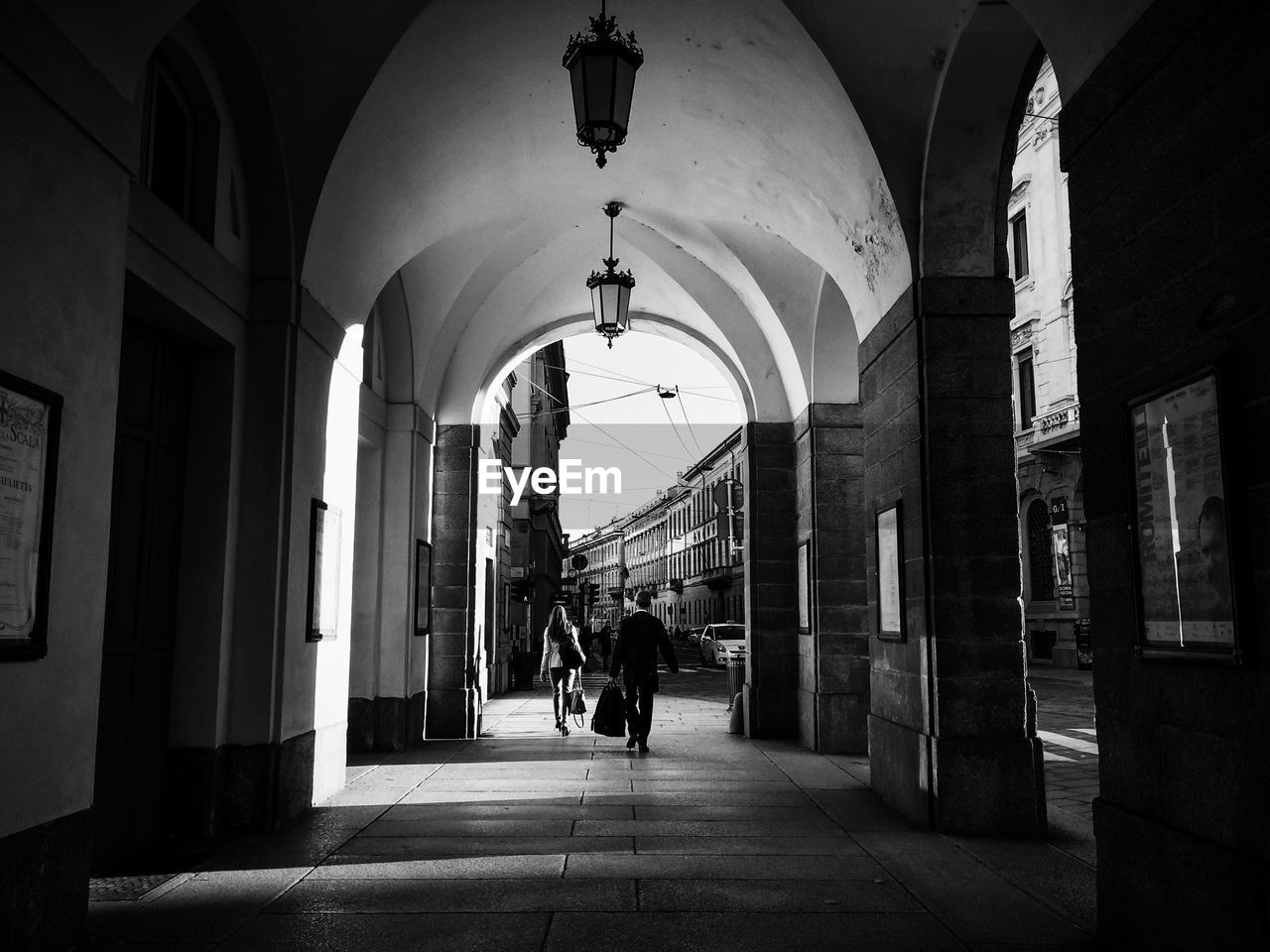 Rear view of people walking in corridor