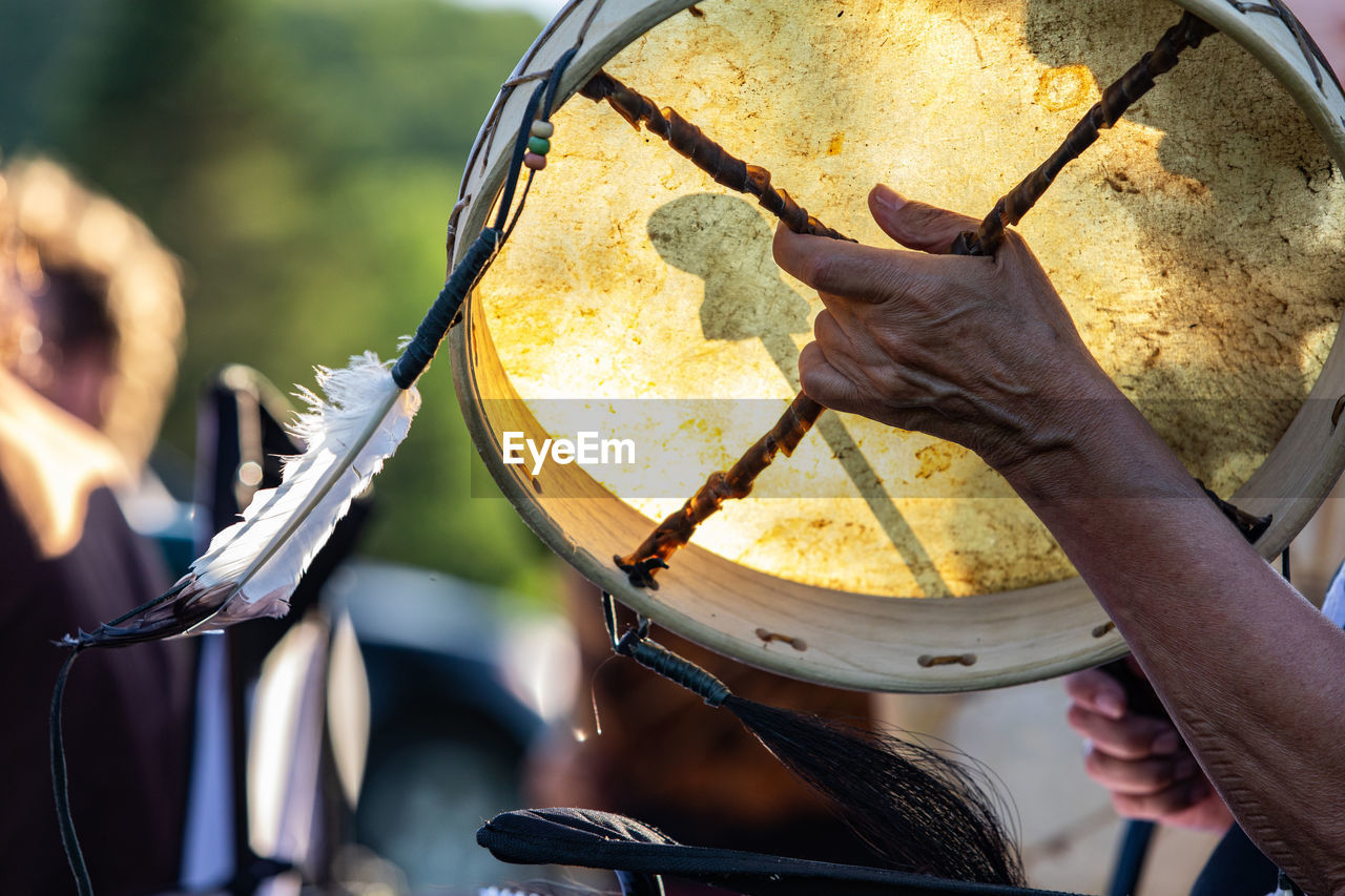 Close-up of hand holding drum