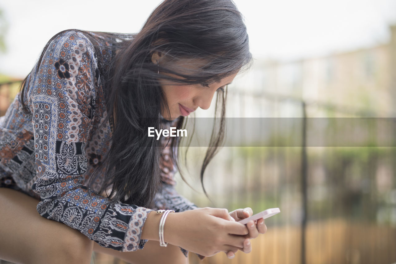 Young woman using her smart phone